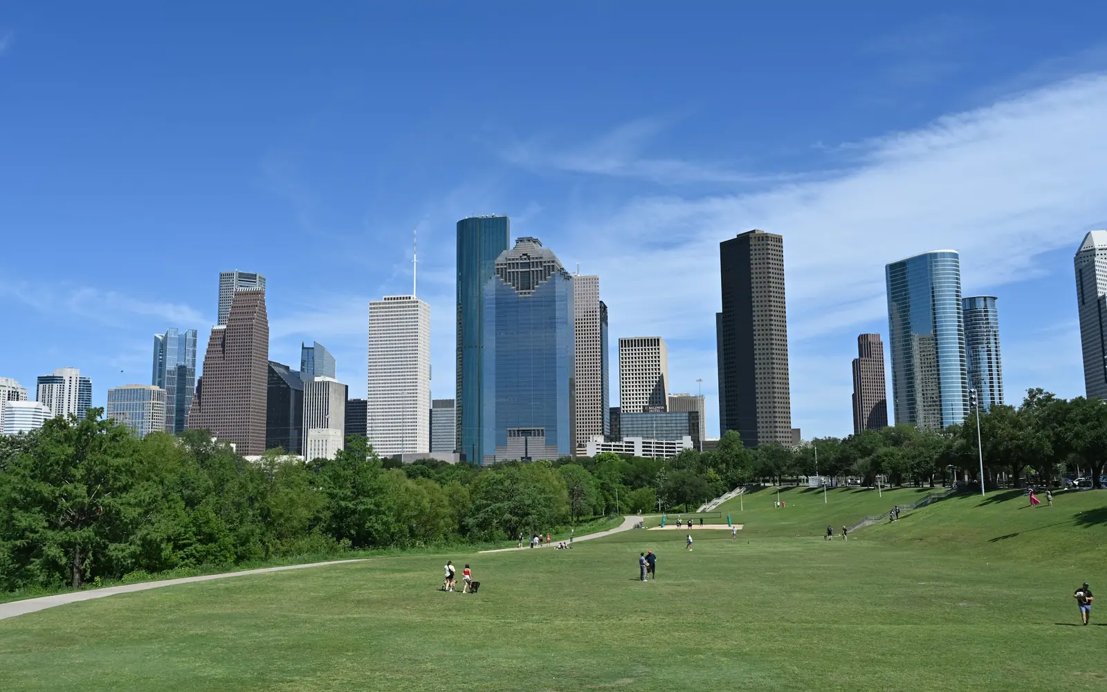 Downtown Houston skyline rising above the green lawns of Buffalo Bayou Park